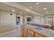 Finished basement with bar area with sink, tile countertop, and carpeted floors at 22021 Pebble Brook Ln, Parker, CO 80138