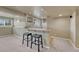 Finished basement with bar area and seating, plus kitchen area with refrigerator at 22021 Pebble Brook Ln, Parker, CO 80138
