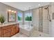 Well-lit bathroom showcasing a glass-enclosed shower and soaking tub at 22021 Pebble Brook Ln, Parker, CO 80138