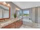 Modern bathroom features dual sinks, a soaking tub, and a glass-enclosed shower at 22021 Pebble Brook Ln, Parker, CO 80138