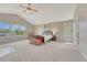 Spacious primary bedroom with vaulted ceilings, a ceiling fan, and large windows at 22021 Pebble Brook Ln, Parker, CO 80138