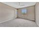 This is a bedroom with neutral walls, carpet, a ceiling fan, and a window for natural light at 22021 Pebble Brook Ln, Parker, CO 80138