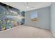 Light-blue bedroom with carpet, fan, and vibrant mural of marine life on accent wall at 22021 Pebble Brook Ln, Parker, CO 80138