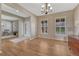 Formal dining room with hardwood floors, natural light, and an elegant chandelier at 22021 Pebble Brook Ln, Parker, CO 80138
