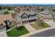 Charming two-story home with a well-maintained front lawn and a spacious driveway in a Gathering-friendly neighborhood at 22021 Pebble Brook Ln, Parker, CO 80138