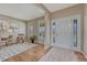 Bright foyer with hardwood floors, decorative rug, stylish furniture, and a front door with decorative glass inserts at 22021 Pebble Brook Ln, Parker, CO 80138