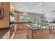 Gourmet kitchen featuring stainless steel appliances, granite counters, and dining area views at 22021 Pebble Brook Ln, Parker, CO 80138