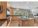 Beautiful kitchen featuring wood cabinets, granite countertops, and a central island cooktop at 22021 Pebble Brook Ln, Parker, CO 80138