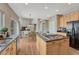 Well-equipped kitchen with modern appliances, central island, and view to dining area at 22021 Pebble Brook Ln, Parker, CO 80138