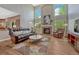 Spacious living room with high ceilings, fireplace, and lots of natural light at 22021 Pebble Brook Ln, Parker, CO 80138
