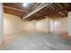 Unfinished basement with exposed ceiling and concrete floor, providing ample space for customization at 100 S University Blvd # 11, Denver, CO 80209