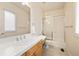 Bright bathroom featuring a shower/tub combo and a sink with wooden cabinetry and a tiled countertop at 100 S University Blvd # 11, Denver, CO 80209