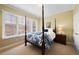 Cozy bedroom with four-poster bed, large window with blinds, and calming color palette at 100 S University Blvd # 11, Denver, CO 80209