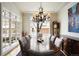 Elegant dining room with large window, chandelier and plush seating at 100 S University Blvd # 11, Denver, CO 80209