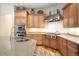 Bright kitchen featuring stainless steel appliances, custom cabinets, granite countertops, and hardwood floors at 100 S University Blvd # 11, Denver, CO 80209