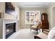 Cozy living room featuring a fireplace, plush chairs, and natural light from a large window at 100 S University Blvd # 11, Denver, CO 80209