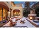 Inviting patio featuring a stone fireplace and cozy seating, ideal for enjoying the snowy outdoor ambiance at 100 S University Blvd # 11, Denver, CO 80209