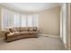 Bright sitting room with multiple windows and white shutters, neutral tones, and comfortable seating at 100 S University Blvd # 11, Denver, CO 80209