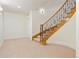 Inviting entry with carpet and a staircase featuring wooden steps and an ornate wrought iron banister at 100 S University Blvd # 11, Denver, CO 80209