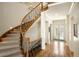 Elegant curved staircase with wood and iron details, adding a touch of sophistication to the entryway at 100 S University Blvd # 11, Denver, CO 80209