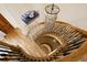 Sweeping staircase featuring a modern chandelier and beautiful wood flooring at 100 S University Blvd # 11, Denver, CO 80209