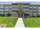 Well maintained exterior of a 4-story building with manicured lawn and walkway leading to the front entrance at 635 S Alton Way # 12C, Denver, CO 80247