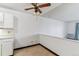 Empty dining area featuring neutral walls, a vintage ceiling fan, and tan flooring at 635 S Alton Way # 12C, Denver, CO 80247