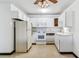 Bright kitchen with white cabinetry, updated appliances, and a classic ceiling fan fixture at 635 S Alton Way # 12C, Denver, CO 80247