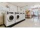 Community laundry room features rows of machines at 635 S Alton Way # 12C, Denver, CO 80247