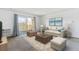 Bright living room with a sliding glass door to the balcony and comfortable seating arrangement at 635 S Alton Way # 12C, Denver, CO 80247
