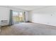 Bright living room featuring a balcony and neutral carpeting at 635 S Alton Way # 12C, Denver, CO 80247