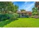 Serene backyard showcasing a well-maintained lawn, inviting patio, and charming garden beds at 5047 S Mabre Ct, Littleton, CO 80123