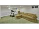 This finished basement offers a treadmill and sectional sofa for relaxing at 5047 S Mabre Ct, Littleton, CO 80123