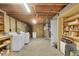 Spacious unfinished basement with utility access and storage shelves, ready for customization at 5047 S Mabre Ct, Littleton, CO 80123
