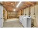 Unfinished basement with laundry area and large built-in shelving for storage, providing ample space at 5047 S Mabre Ct, Littleton, CO 80123