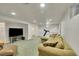 Spacious finished basement area featuring recessed lighting, neutral walls and comfy sofa at 5047 S Mabre Ct, Littleton, CO 80123