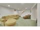 Finished basement featuring plush carpet, sectional sofa and a staircase at 5047 S Mabre Ct, Littleton, CO 80123
