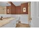 Bathroom showcasing a marble vanity with storage, tiled floors, and a shower-tub combo for convenience at 5047 S Mabre Ct, Littleton, CO 80123