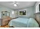 This bedroom offers a ceiling fan, window with green foliage, and a charming vanity at 5047 S Mabre Ct, Littleton, CO 80123