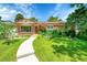 Charming brick home with a well-manicured lawn, colorful flowerbeds, and inviting walkway at 5047 S Mabre Ct, Littleton, CO 80123