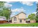 Outdoor living is easy in this backyard with lush lawn, patio, and mature trees at 5262 E Sandpiper Ave, Castle Rock, CO 80104