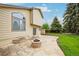 Inviting backyard with stone patio, fire pit, grassy area, and home's exterior at 5262 E Sandpiper Ave, Castle Rock, CO 80104