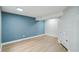 Finished basement with hardwood floors and a cool-toned accent wall at 5262 E Sandpiper Ave, Castle Rock, CO 80104