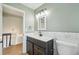 The renovated bathroom features elegant lighting and a dark wood vanity at 5262 E Sandpiper Ave, Castle Rock, CO 80104
