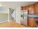 Open kitchen features stainless steel refrigerator, sleek cabinets, and a seamless transition to the staircase at 5262 E Sandpiper Ave, Castle Rock, CO 80104