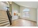 Light filled living area boasts luxury vinyl floors, a dramatic window and access to the staircase at 5262 E Sandpiper Ave, Castle Rock, CO 80104