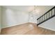 Bright living room features luxury vinyl flooring, modern lighting and staircase leading to the upper level at 5262 E Sandpiper Ave, Castle Rock, CO 80104