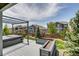 Backyard featuring a well-maintained deck with a hot tub and landscaped yard at 16978 W 87Th Ave, Arvada, CO 80007