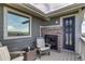 Deck featuring an outdoor fireplace with picturesque mountain views through a window at 16978 W 87Th Ave, Arvada, CO 80007