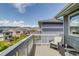 Relaxing deck with chairs, table, and views of the community and scenic mountains at 16978 W 87Th Ave, Arvada, CO 80007